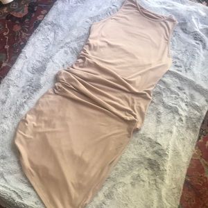 Flattering neutral nude colored asymmetric sleeves dress with scoop neck.